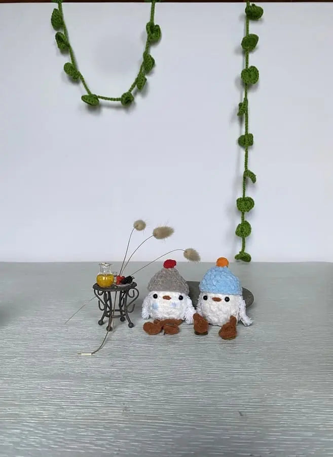 Two litlle ducklings with pom-pom hats