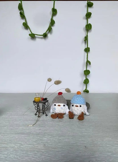 Two litlle ducklings with pom-pom hats