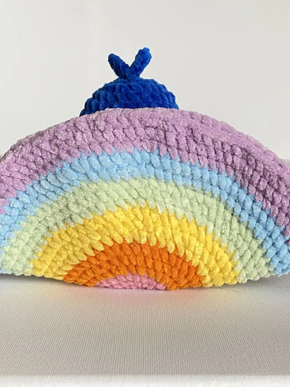 A blue peacock seen from behind with a rainbow tail from tchiptchip a crochet pattern shop